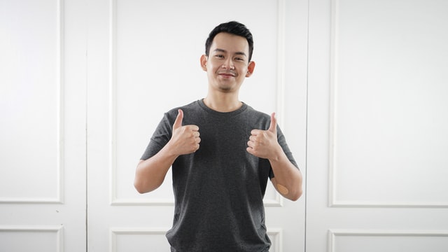 A man showing thumbs up with two hands