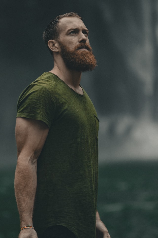 A portrait of a man with red colored beard in olive t-shirt 