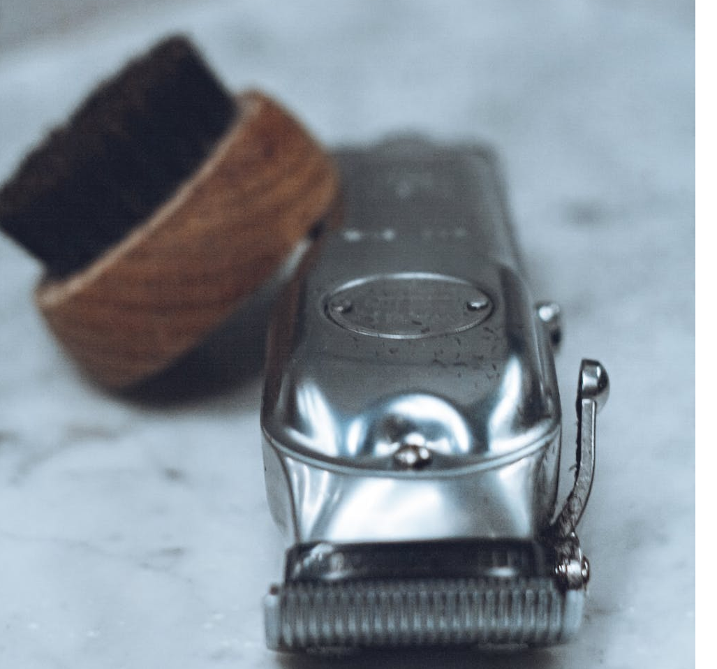 An image of a beard trimmer with a brush