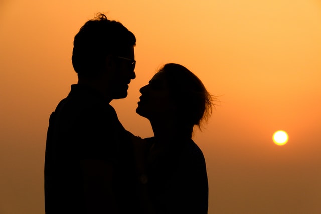 A portrait of a closeup couple hugging them at sunset time  