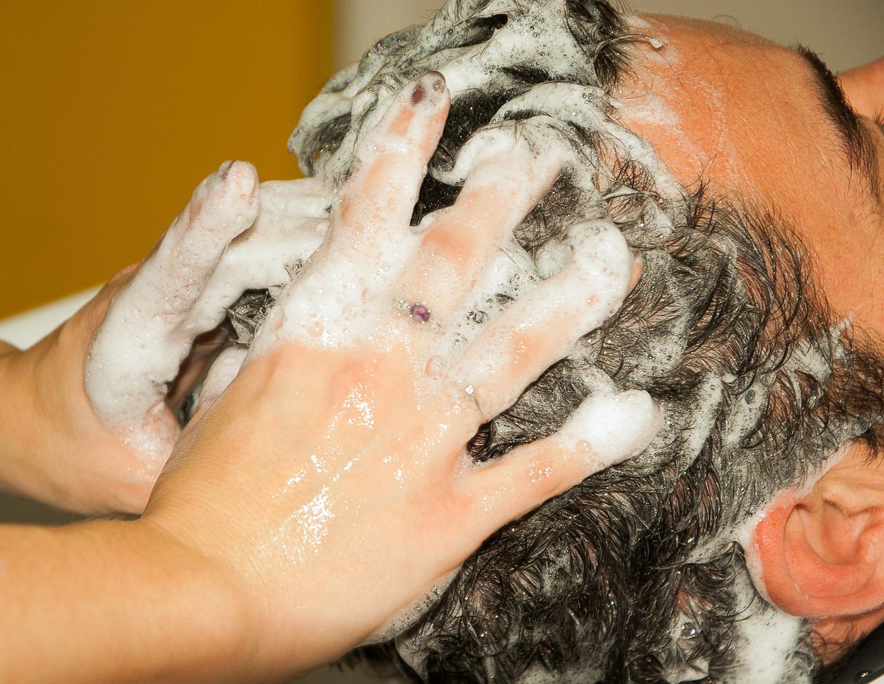 A closeup portrait of washing men's hair