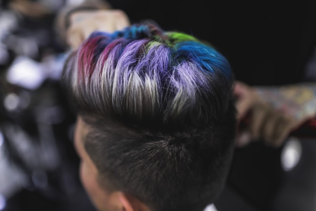 Portrait of a man's hair top while color while dyeing hair at barber shop