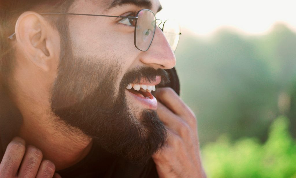 A closeup portrait of nicely trimmed beard man with smiley face