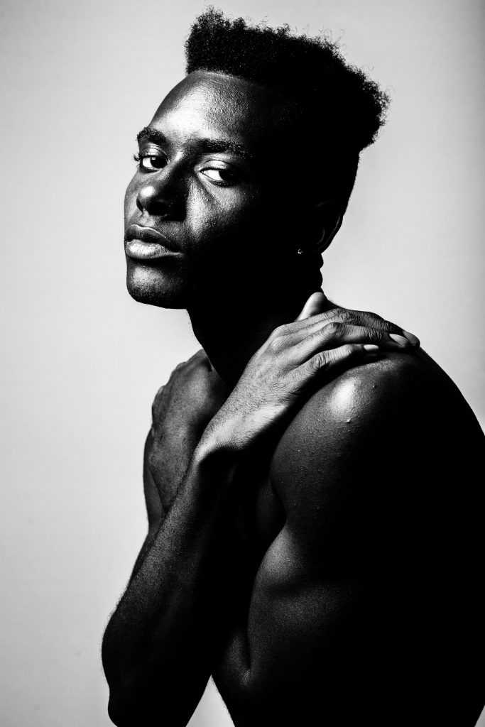 A portrait of a black man with enlighten skin