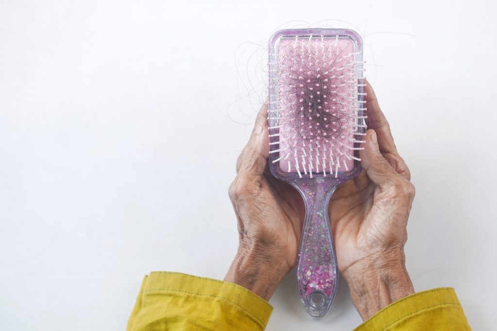 An image of a comb with loosen hair after brushing