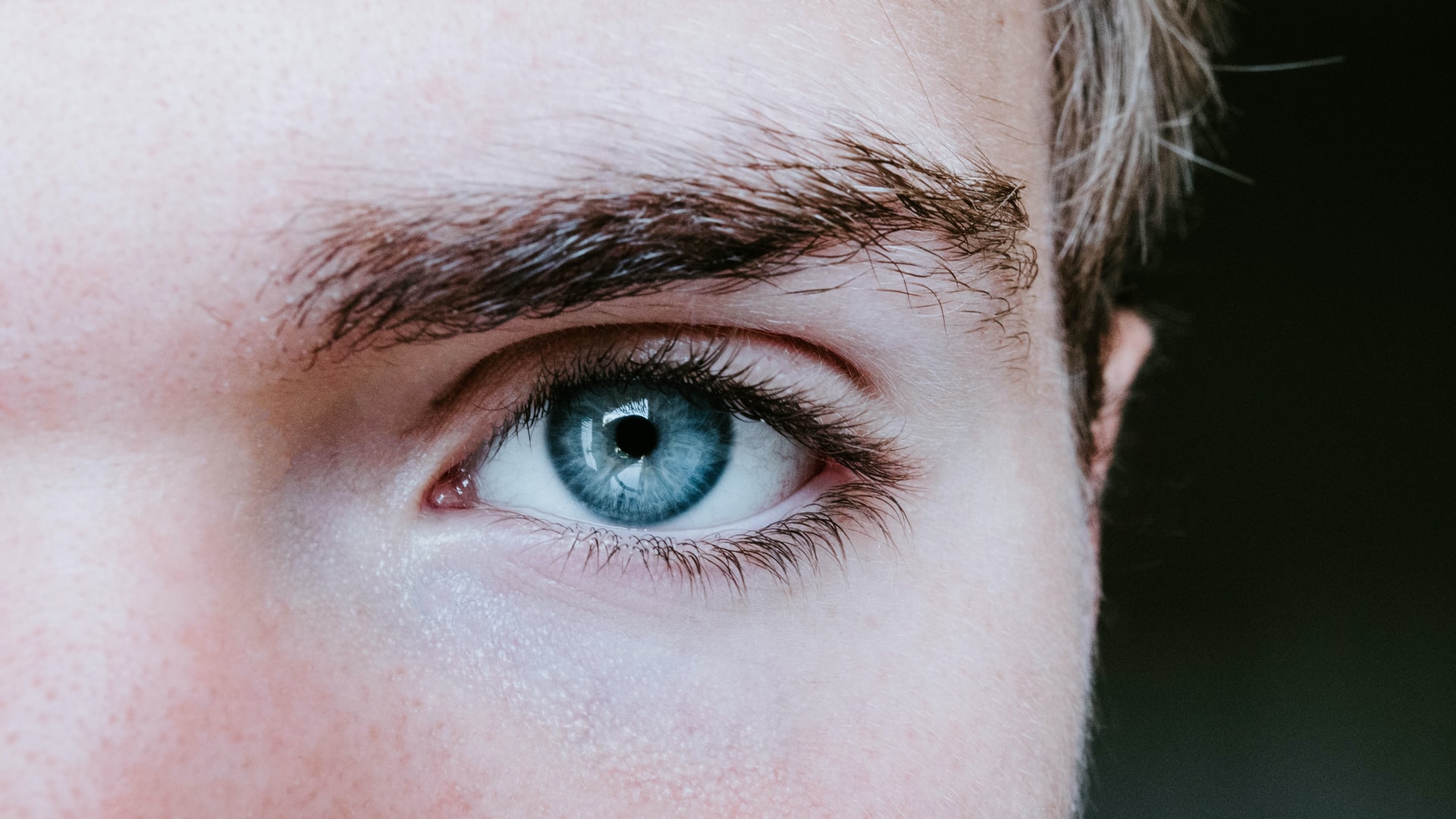 Closeup portrait of round eyebrows of a man's 
