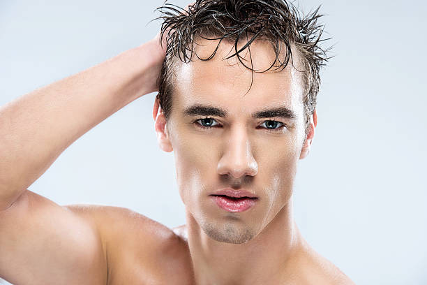 A young man with wet hair after shower